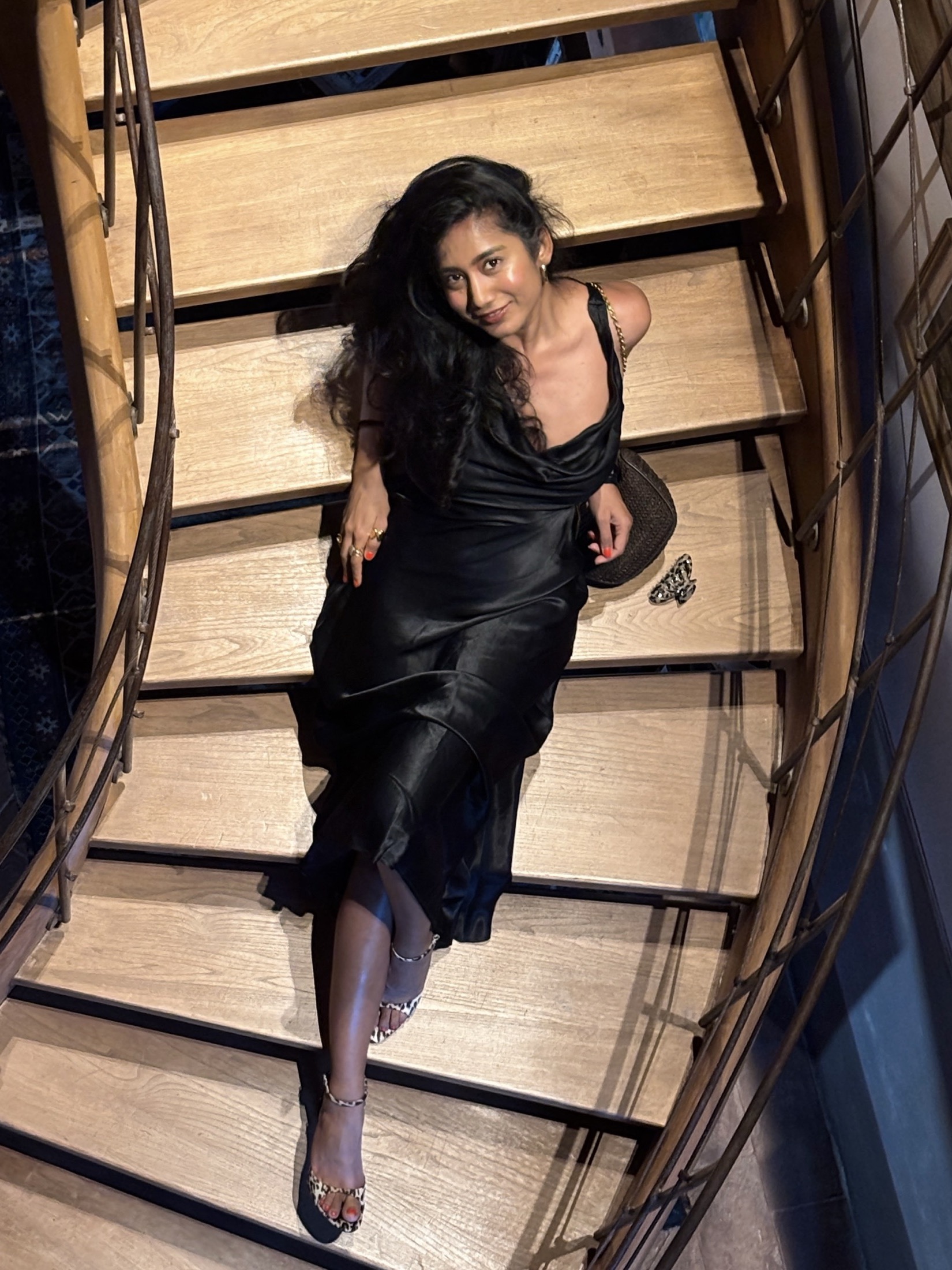 Deepshika on a staircase in a black dress